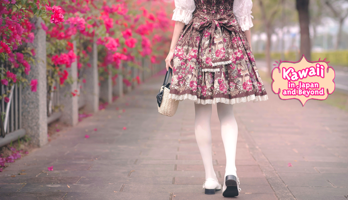 Lower body of a figure walking away from the viewer, wearing a frilly pink dress to the knees, white tights, and carrying a wicker bag with a black patent bow; a street with a stone fence and bright pink flowers in the background