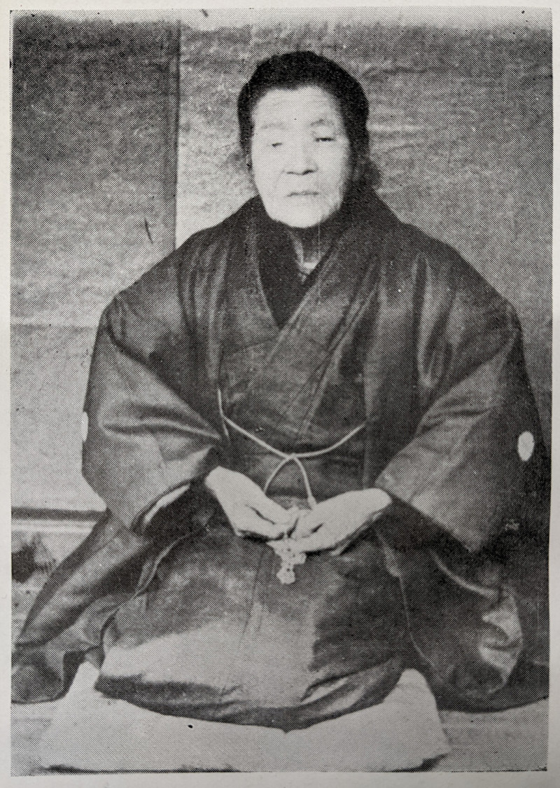 Black and white photograph of an elderly Japanese woman dressed in kimono and seated. Her name was Urakawa Mori and she was a a Sempuku Kirishitan Hidden Christian and survivor of the Urakami Fourth Persecution.