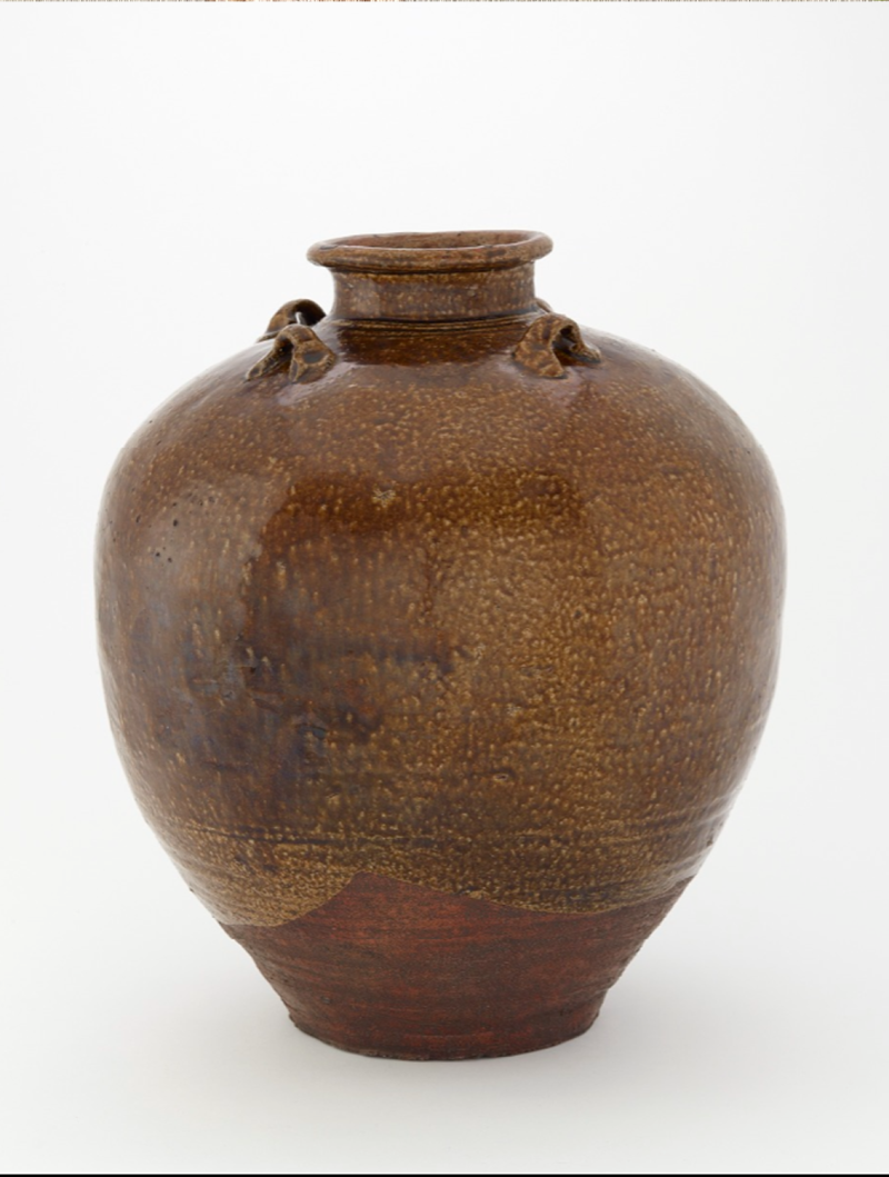 Large brown ceramic jar with a mottled texture and small ceramic loops that could hold cords.